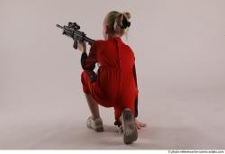 DENISA KNEELING POSE WITH GUN